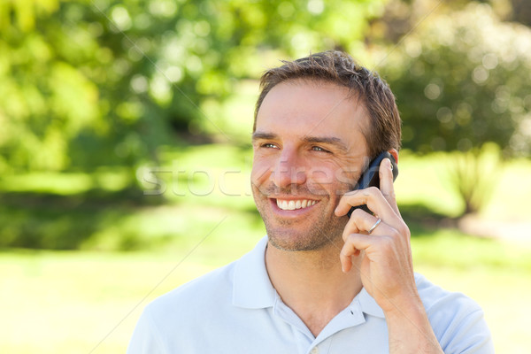 Handsome man phoning in the park Stock photo © wavebreak_media