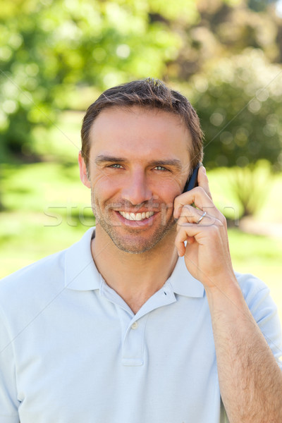 Handsome man phoning in the park Stock photo © wavebreak_media