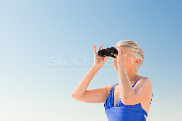 Senior woman bird watching at the beach Stock photo © wavebreak_media
