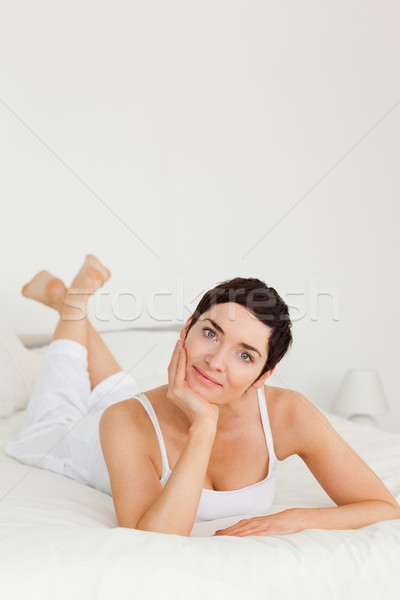 Portrait charmant femme posant lit sourire [[stock_photo]] © wavebreak_media