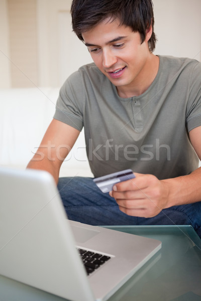 Portrait of a man shopping online in his living room Stock photo © wavebreak_media