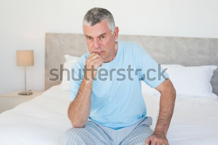 Stock photo: Tired man yawning in his bedroom