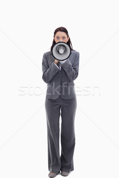 Expressive businesswoman speaking in a megaphone against white background Stock photo © wavebreak_media