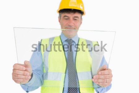 Mature architect with plans and helmet against a white background Stock photo © wavebreak_media
