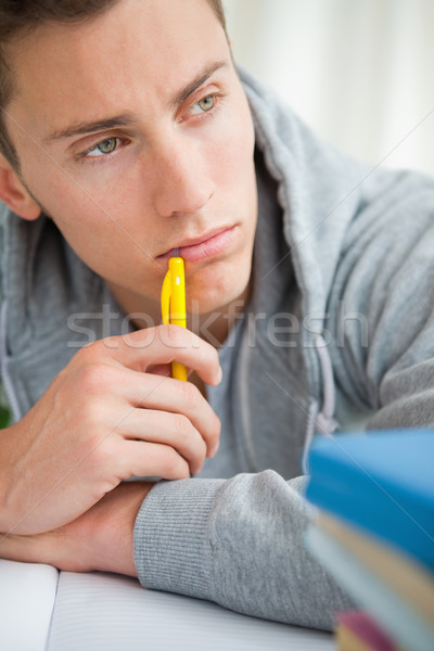 Close-up of a depressed student chewing his pencil on his desk Stock photo © wavebreak_media