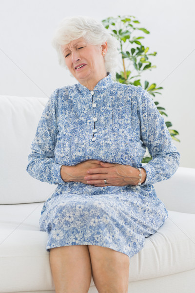 Elderly woman suffering with a belly pain Stock photo © wavebreak_media