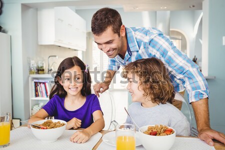 Family looking at the camera at dinner time Stock photo © wavebreak_media