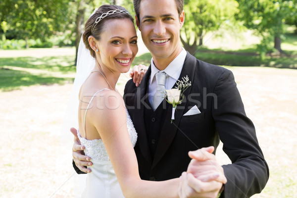 Happy bride and groom dancing together in garden Stock photo © wavebreak_media