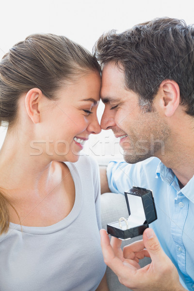 Happy couple getting engaged on the sofa Stock photo © wavebreak_media