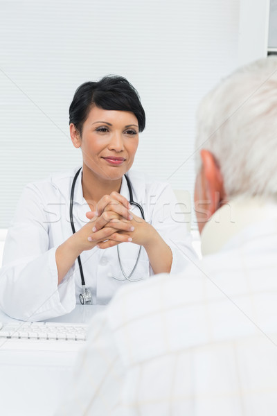 Young female doctor attentively listening to senior patient Stock photo © wavebreak_media
