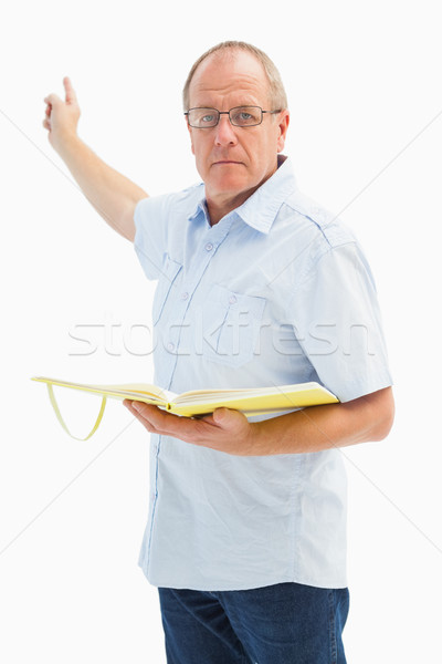 Stock photo: Serious preacher man pointing and holding gospel