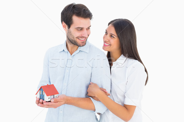 Attractive young couple holding a model house Stock photo © wavebreak_media