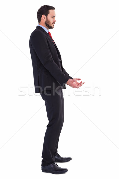 Unsmiling businessman holding something with his hands Stock photo © wavebreak_media