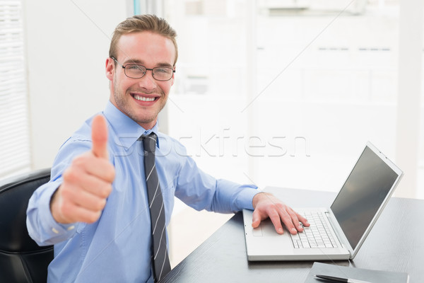 Positive businessman with glasses and thumb up Stock photo © wavebreak_media