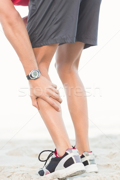 Fitt férfi izomfájdalom tengerpart tavasz fitnessz Stock fotó © wavebreak_media