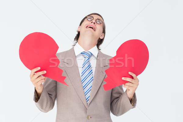 Geeky businessman crying and holding broken heart card Stock photo © wavebreak_media