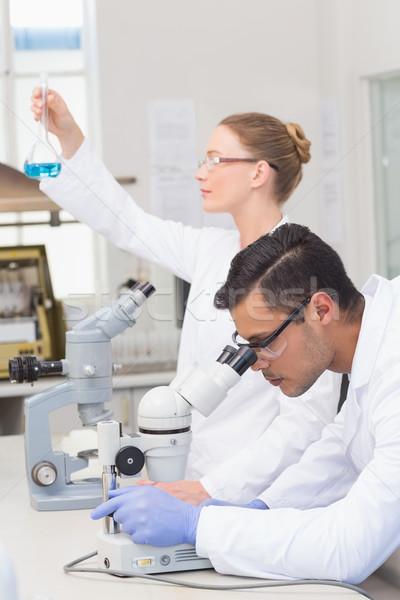 Stock photo: Scientists examining blue precipitate 