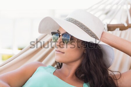 Pretty brunette relaxing on a hammock and texting with her mobil Stock photo © wavebreak_media