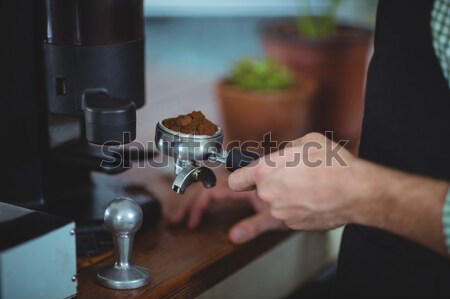 Stock photo: Close up of a barista pressing coffee