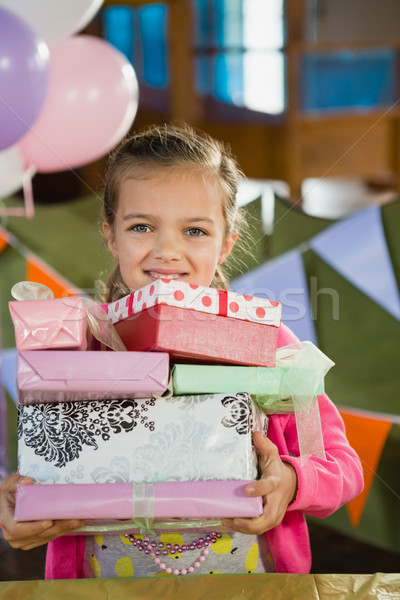 Birthday girl holding various gift boxes at home Stock photo © wavebreak_media
