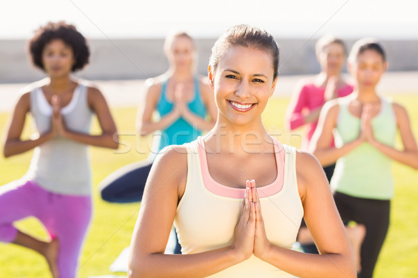 Smiling sporty brunette doing yoga in yoga class Stock photo © wavebreak_media