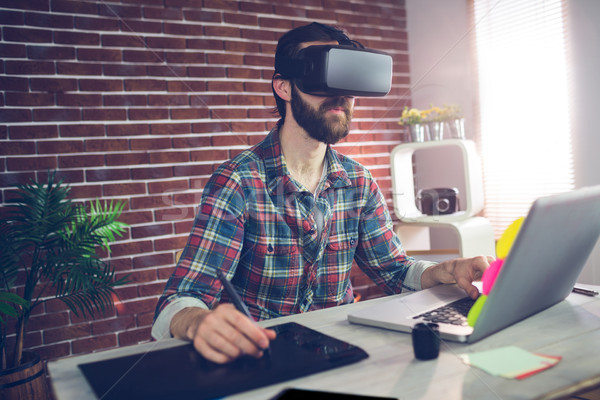 Serious creative businessman using 3D video glasses and laptop Stock photo © wavebreak_media
