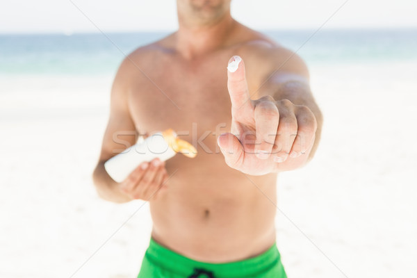Portrait of man applying sun cream Stock photo © wavebreak_media