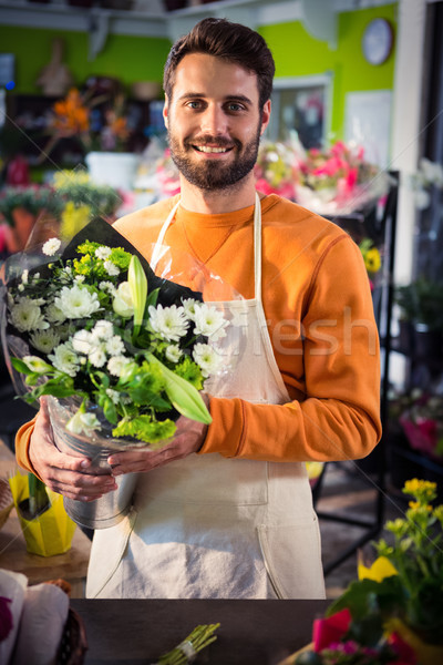 Male florist holding flower bouquet at flower shop Stock photo © wavebreak_media