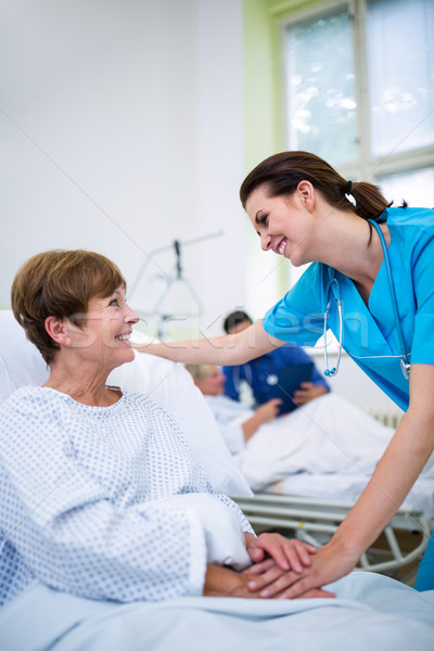 Nurse consoling a patient in hospital ward Stock photo © wavebreak_media