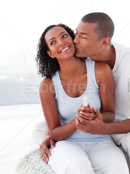 Cheerful couple finding out results of a pregnancy test in the bedroom Stock photo © wavebreak_media