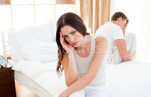 Upset couple sitting separately on their bed Stock photo © wavebreak_media