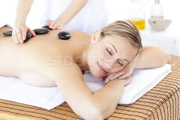 Pretty young woman receiving a massage with hot stone Stock photo © wavebreak_media