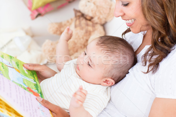 Joyful mother showing images in a book to her cute little son Stock photo © wavebreak_media