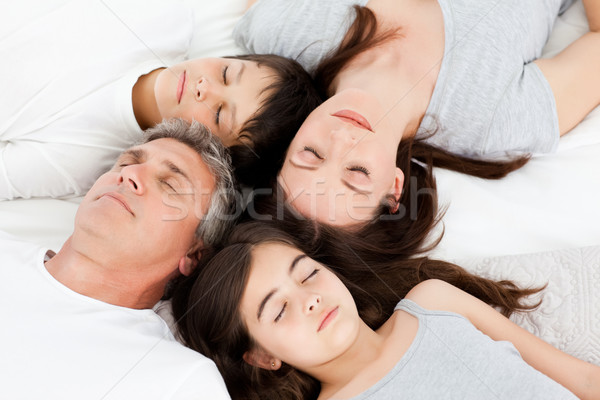 Family lying down on their bed at home Stock photo © wavebreak_media