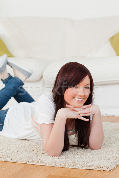 Cute femme posant tapis salon sourire [[stock_photo]] © wavebreak_media