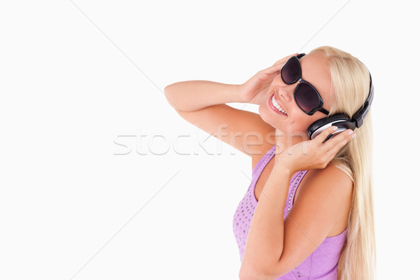 Bájos nő fülhallgató napszemüveg stúdió mosoly Stock fotó © wavebreak_media