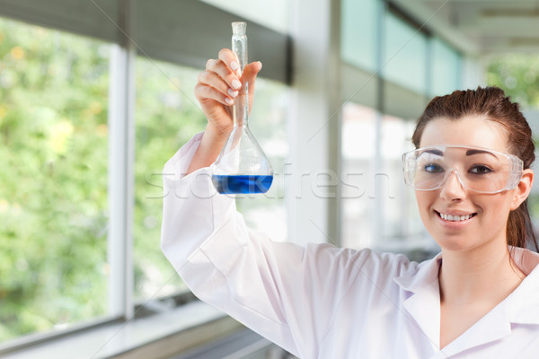 Female science student holding a blue liquid in a laboratory Stock photo © wavebreak_media