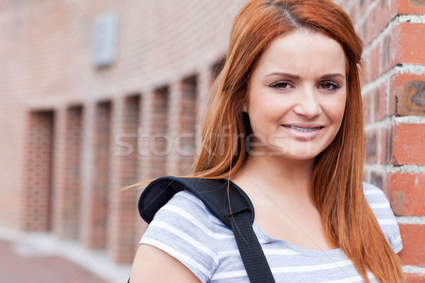 Smiling student looking at the camera outside a building Stock photo © wavebreak_media