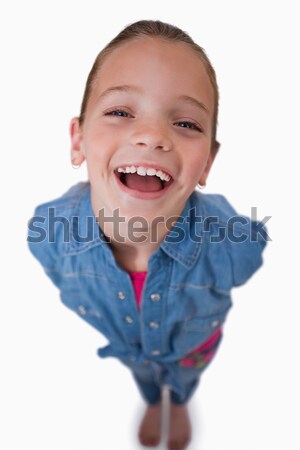 Stock photo: Portrait of a cheerful girl smiling at the camera against a white background
