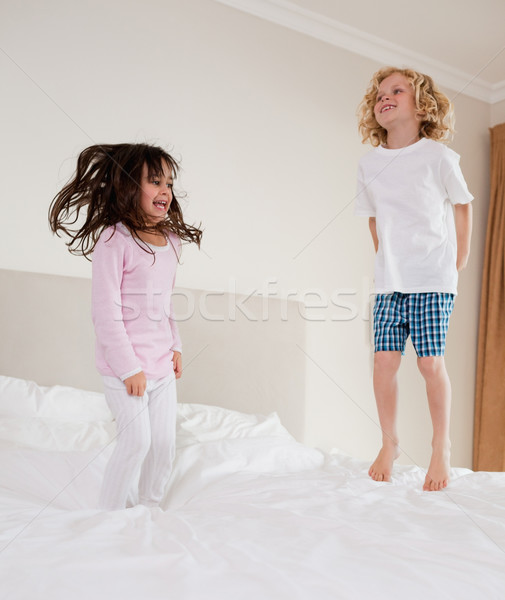 Portrait of children jumping on a bed  Stock photo © wavebreak_media