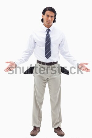 Portrait of an innocent businessman showing his empty pockets against a white background Stock photo © wavebreak_media