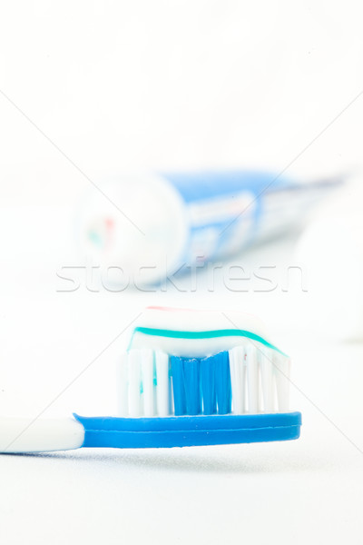 Tooth brush next to a tube of toothpaste against white background Stock photo © wavebreak_media
