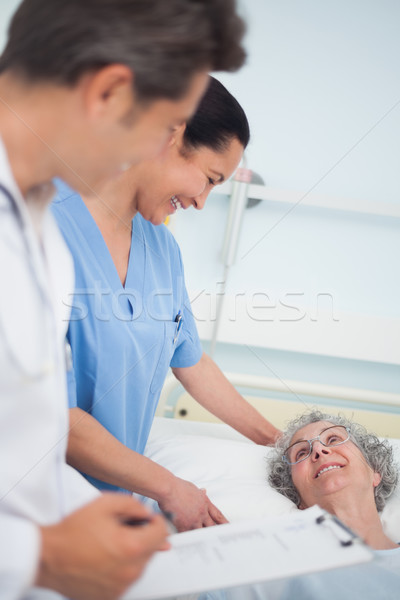 Patient laughing with a nurse and a doctor in hospital ward Stock photo © wavebreak_media