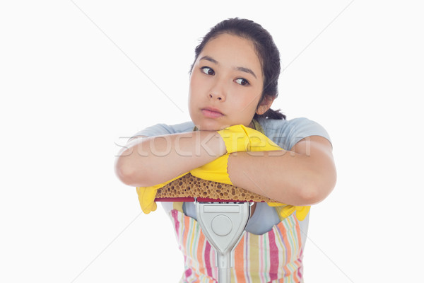 Bored woman leaning on a mop and wearing yellow gloves Stock photo © wavebreak_media