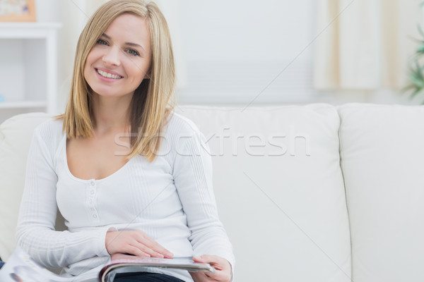 Portrait of happy woman with magazine at home Stock photo © wavebreak_media