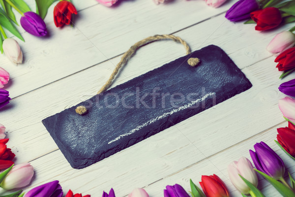 Tulips forming frame around chalkboard Stock photo © wavebreak_media