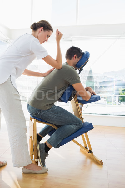 Professional female therapist giving massage to man Stock photo © wavebreak_media