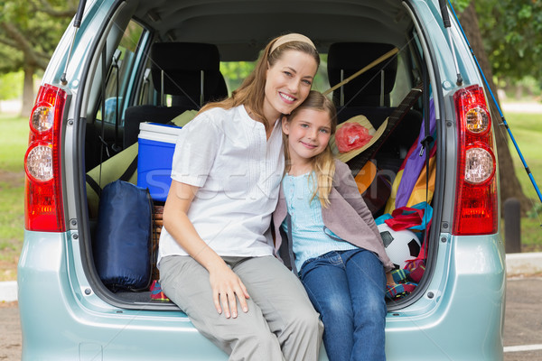 Smiling mother and daughter sitting in car trunk Stock photo © wavebreak_media