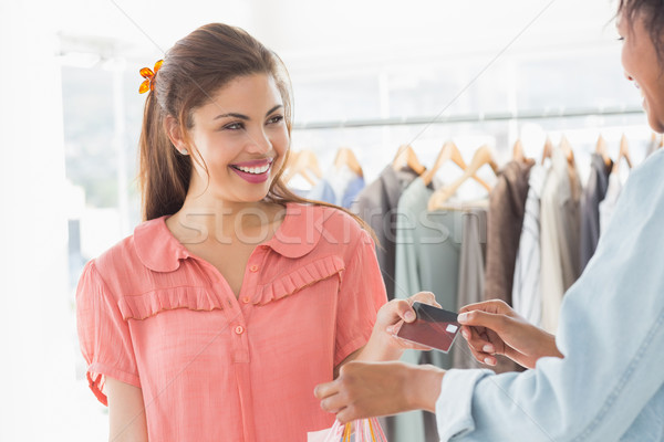 Customer receiving credit card from saleswoman Stock photo © wavebreak_media