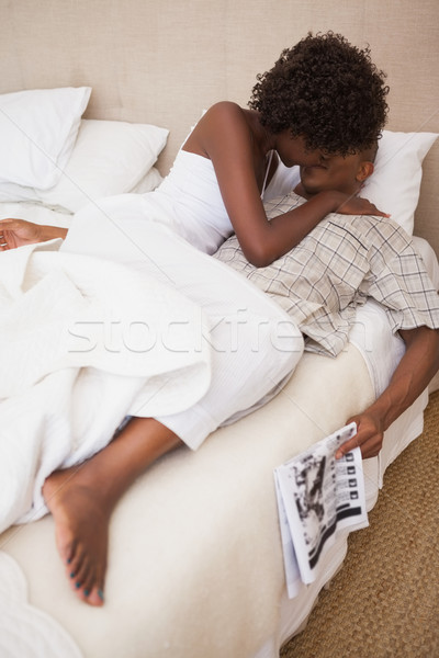 Happy couple in bed together Stock photo © wavebreak_media